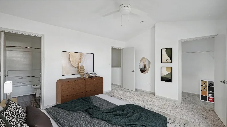 Renovated bedroom with adjoining bathroom at Meridian Apartments in Fort Worth, Texas.