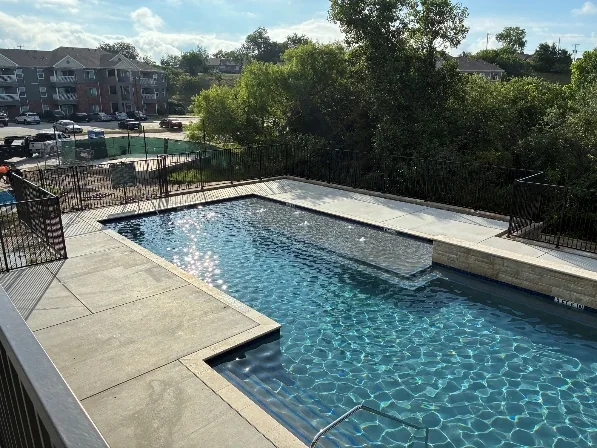 Renovated outdoor swimming pool at Wildwood Branch Apartments in Fort Worth, Texas.